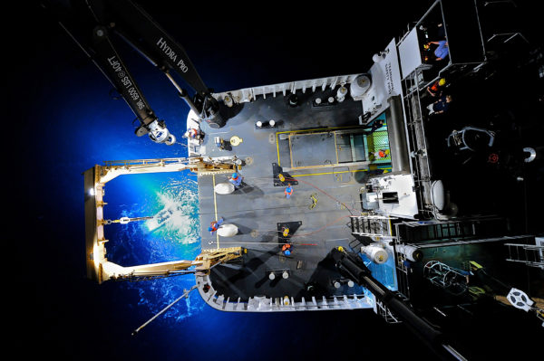 July 24 - Preparing for one last dive A unique down-looking view of a ROV recovery at night. Carl VerPlanck captured this image by strapping his camera to a crane and extending it 30-ft above the deck. Image courtesy of NOAA Okeanos Explorer Program There is much to do before our last possible dive on Monday, July 25. Though we completed a very successful ROV dive on the off-axis sulfide mounts today, the ROV Team will likely be working late into the evening. Serios's HMI lights failed soon after this morning's launch and a vertical thruster on Little Hercules also failed. The Team expects the HMI light issue will be a relatively easy fix. However, The vertical thruster is likely more problematic. The thruster had failed the previous day and had been replaced with a spare. Because we lost the spare the very next day, the ROV Team must look deeper into the system to find the problem. We're hoping that they'll be able to get everything operational in time for one last dive tomorrow morning. Image courtesy of NOAA Okeanos Explorer Program, Galapagos Rift Expedition 2011.